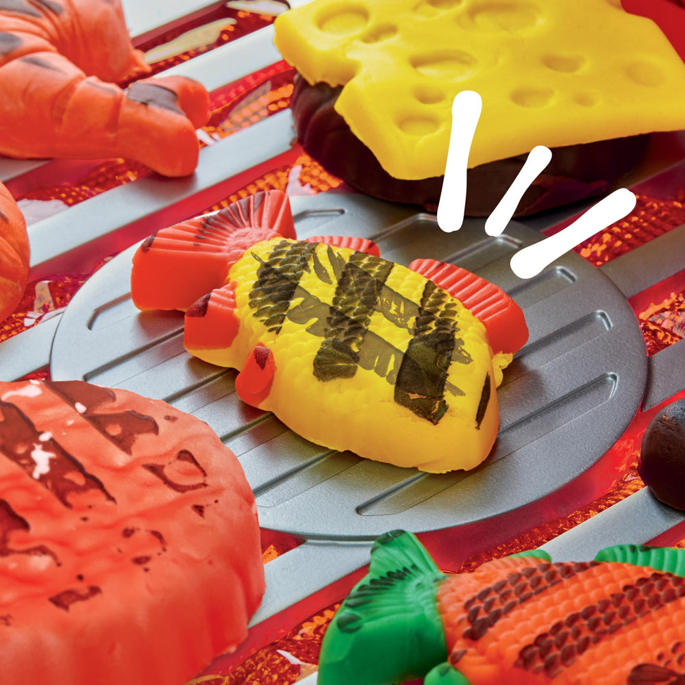 Play-Doh Sizzlin' Grill Playset stamp pad adds grill marks to pretend foods.