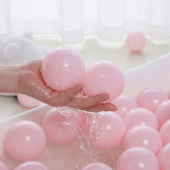 PlayMaty classroom ready pink balls in play tent setting.