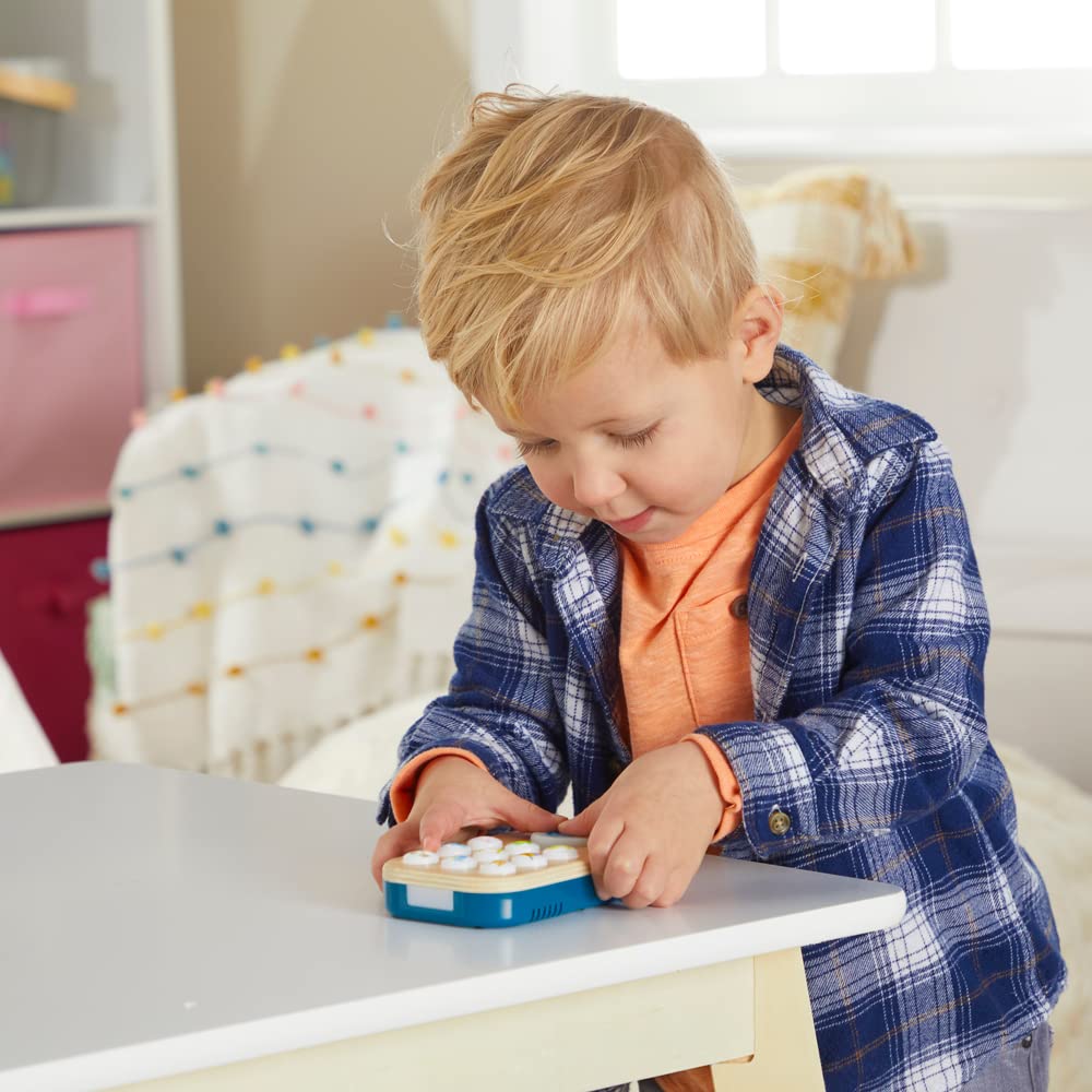 Baby presses buttons on Gimme-A-Ring to explore cause and effect.