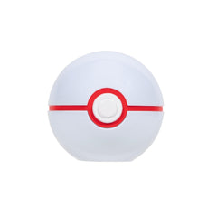 Poké Ball in focus with Charmander figure ready for battle training.