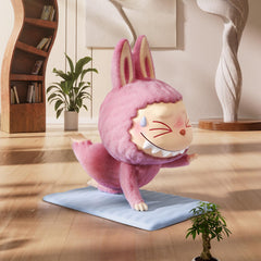 POP MART Lazy Yoga figure serves as a playful desk accent.