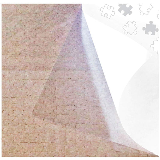 Puzzle EZ clear glue sheets four-pack laid over a finished puzzle for easy preservation.