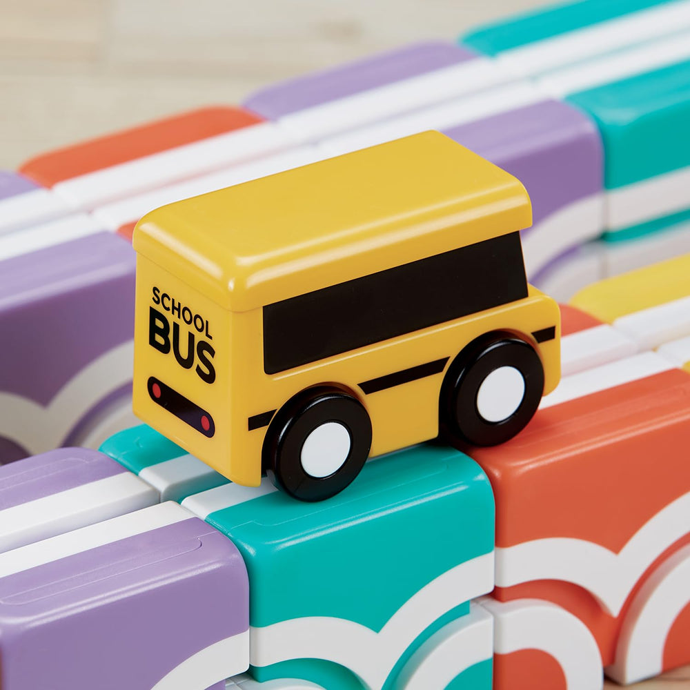 QBI child playing with bus proves portable, travel-friendly learning on the go.