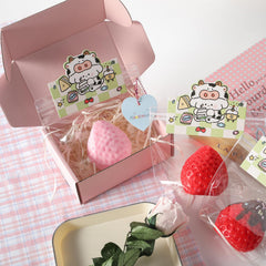 QCROAD SQUISHY red strawberry sauce squishy in use offers potential stress relief during breaks.
