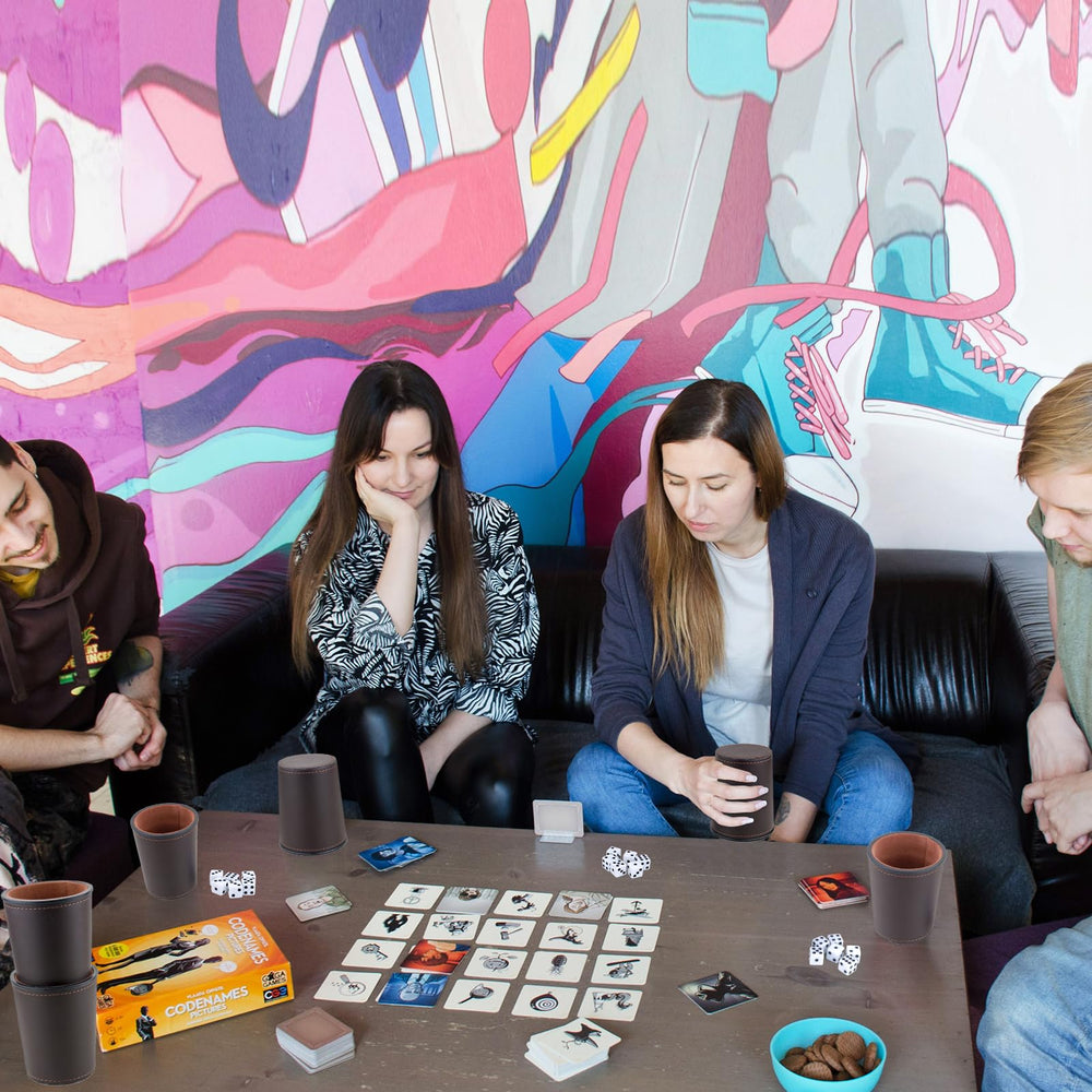 RERIVER dice cups shown in home and pub game setting.