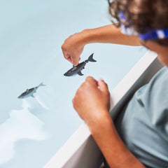 Shark gliding through bubbles, ideal for bath time adventures