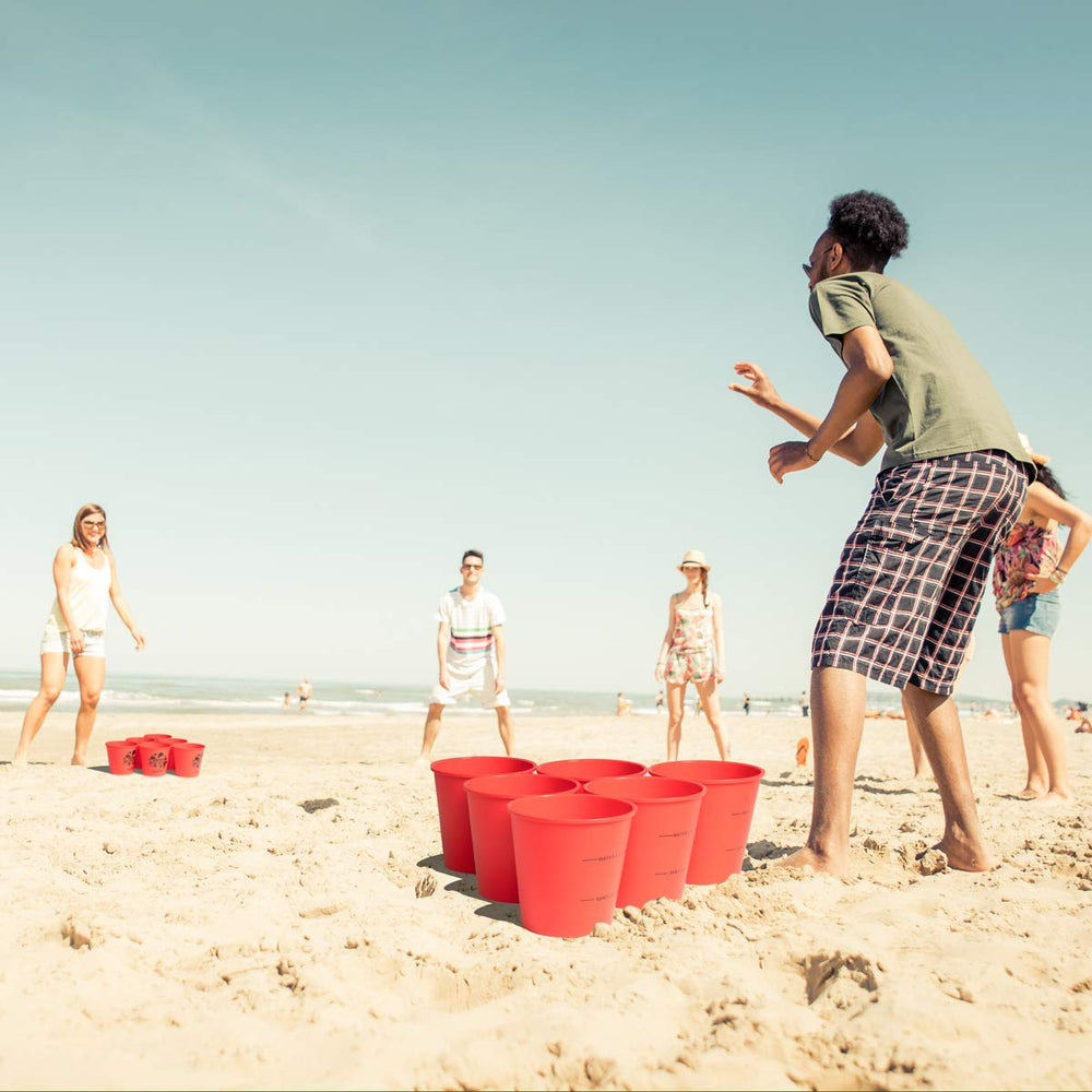 ROPODA Giant Yard Pong glow-in-the-dark setup for evening beach games and glow fun.