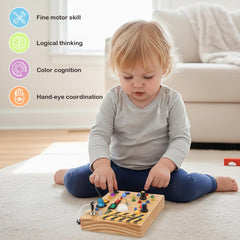 Sanlebi toddler using busy board for screen-free play