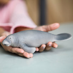 Schleich Wild Life manatee figurine in hand supports portable, hands-on learning about marine life.