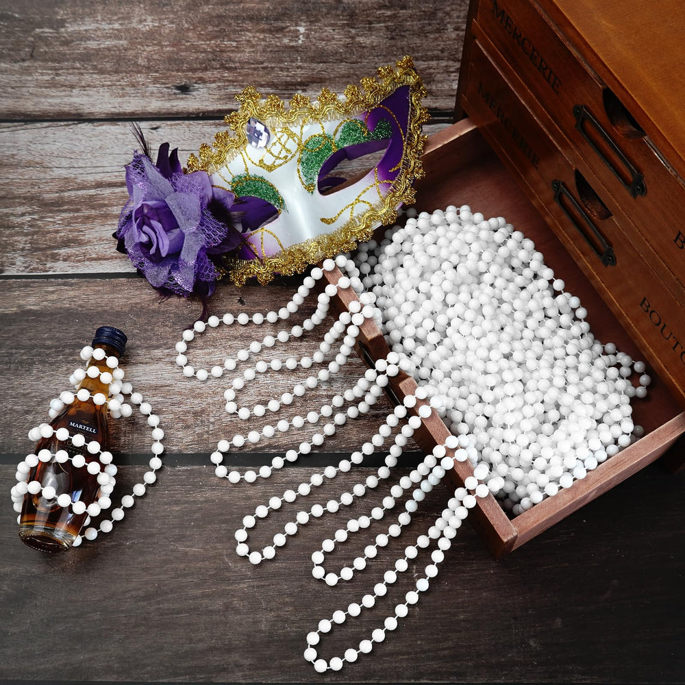 SHAOQINLIN white bead necklaces displayed for parade throws and decor.