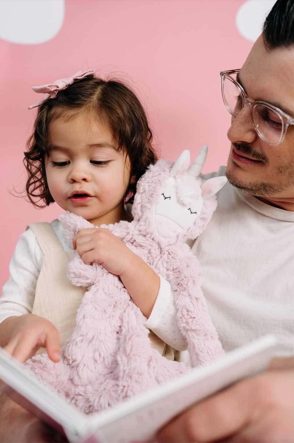 Slumberkins Unicorn Snuggler with child during a calm bedtime routine.