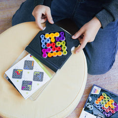 SmartGames IQ Gears gear twist action showing solving process on the puzzle board.