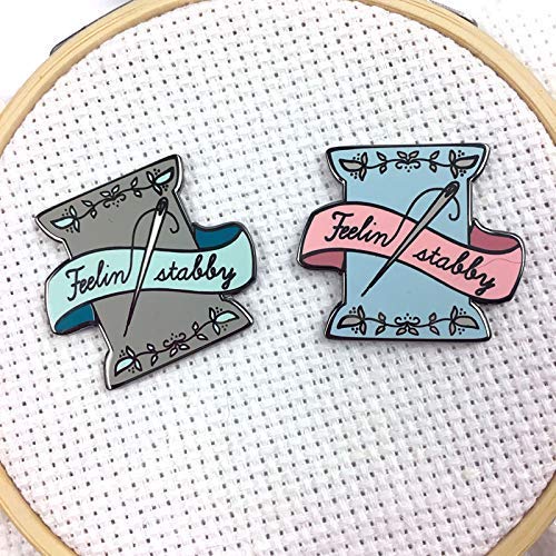 Close-up of Snarky Crafter custom drawn enamel needle minder design