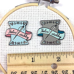 Detail of Snarky Crafter enamel artistry on needle minder with spool motif