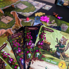 Starling Games Everdell forest city artwork highlights woodland architecture.