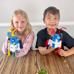 Classroom scene with multiple STEM Inventions doodle bots in a group activity.