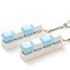 Sumgsn keyboard clicker with four keys held in hand for stress relief.