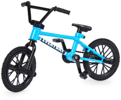 Tech Deck BMX finger bike performing tail whip with compact metal frame.