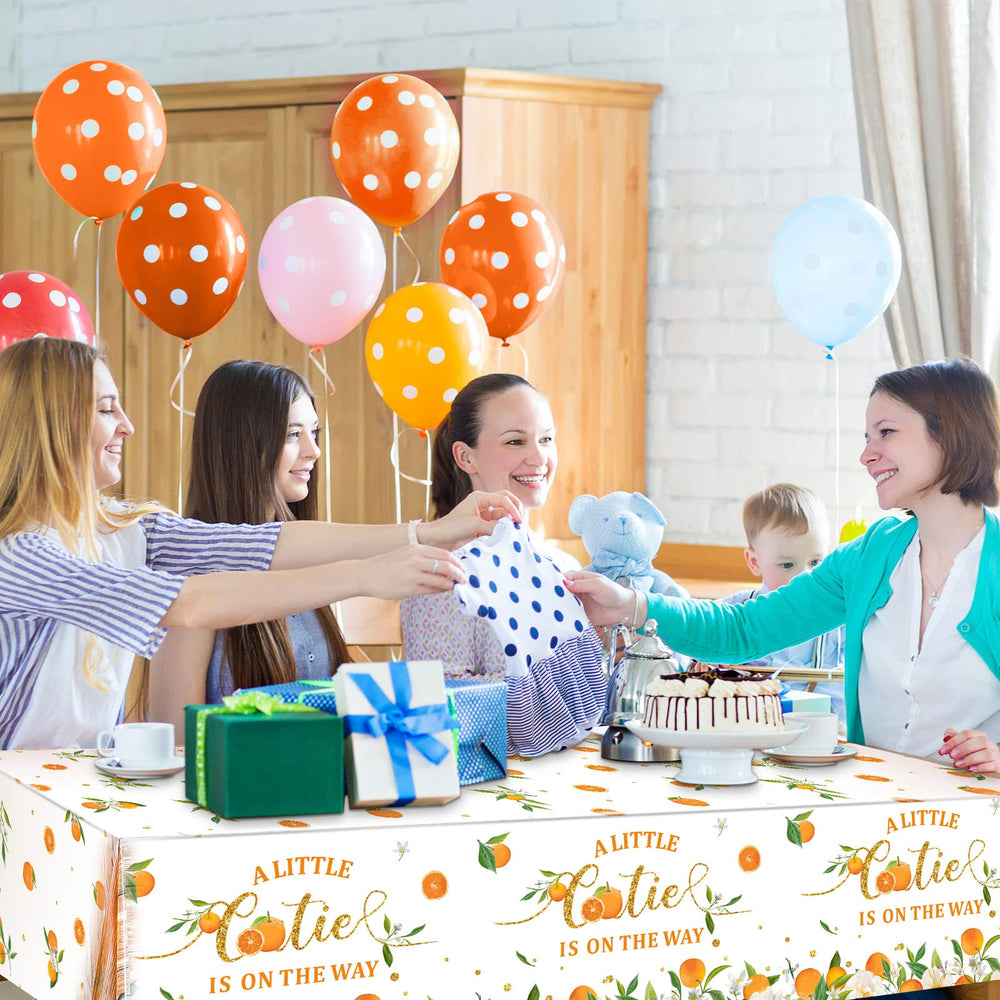 Tegeme baby shower table cover unrolled over a long table