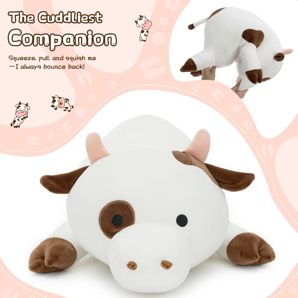 Tezituor large cow plush on bed used as a hug pillow for reading.