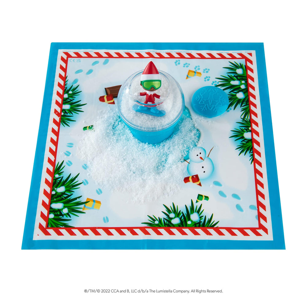 The Elf on the Shelf Secret SnoPrize mini figure emerging from Santa’s snowy reveal
