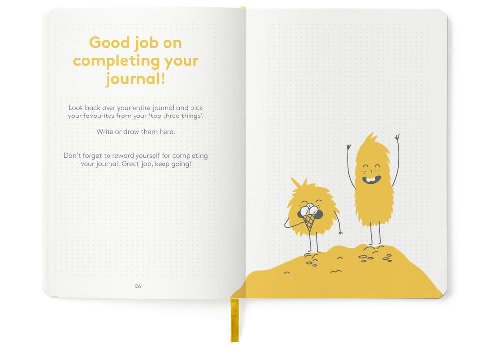 The HappyMe Journal yellow-cover-closeup features a cheerful, kid-friendly design for daily use.
