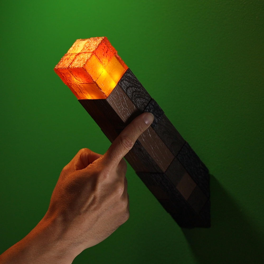 The Noble Collection Minecraft Torch Illuminating Collector battery compartment accessible for simple replacement.