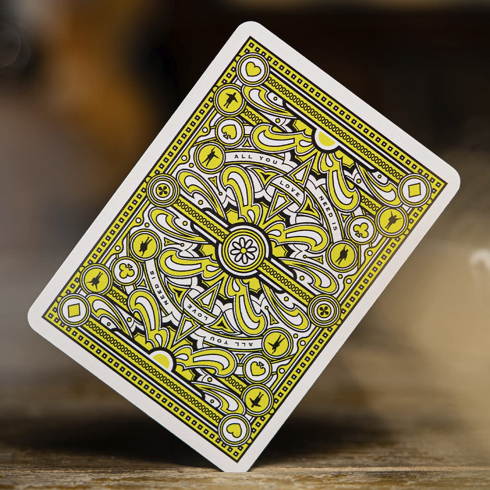 theory11 Beatles Green Deck foiled accents catch light on table.