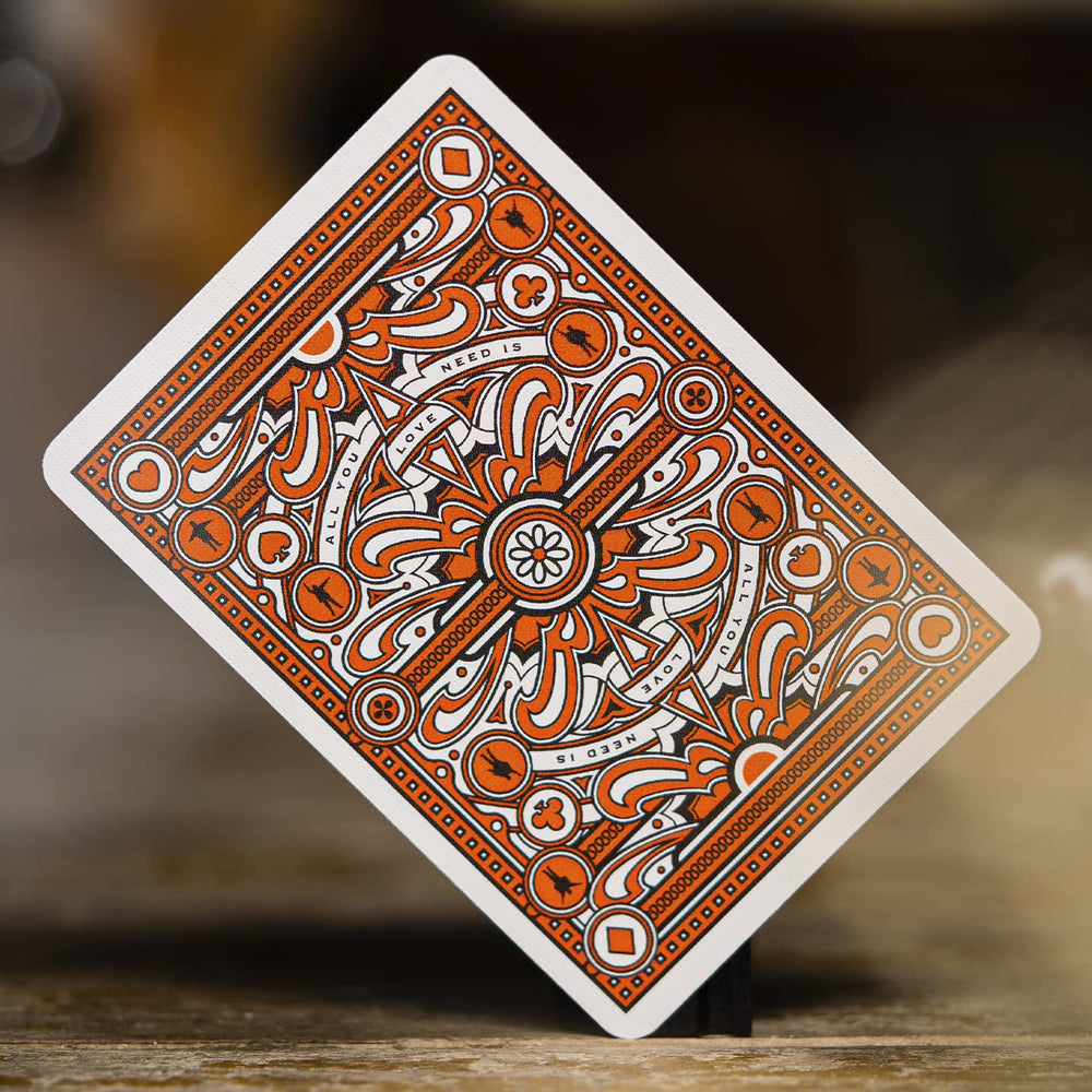theory11 Beatles orange deck foil accents catch light for premium appeal