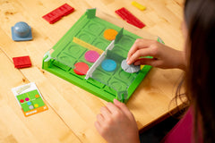 ThinkFun Invasion of the Cow Snatchers magnetic tokens used for puzzle strategy.