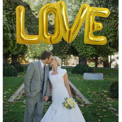 TONIFUL 40 inch gold L balloon as a party focal point.