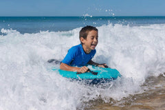 Trivamo beach setup showing family fun with inflatable board.