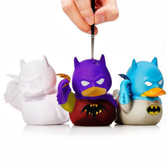 TUBBZ Batman DIY figure during painting session with art supplies nearby.
