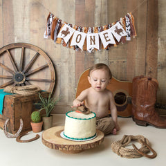 TUTOTU cowboy birthday banner close-up highlights vivid letters and icons.