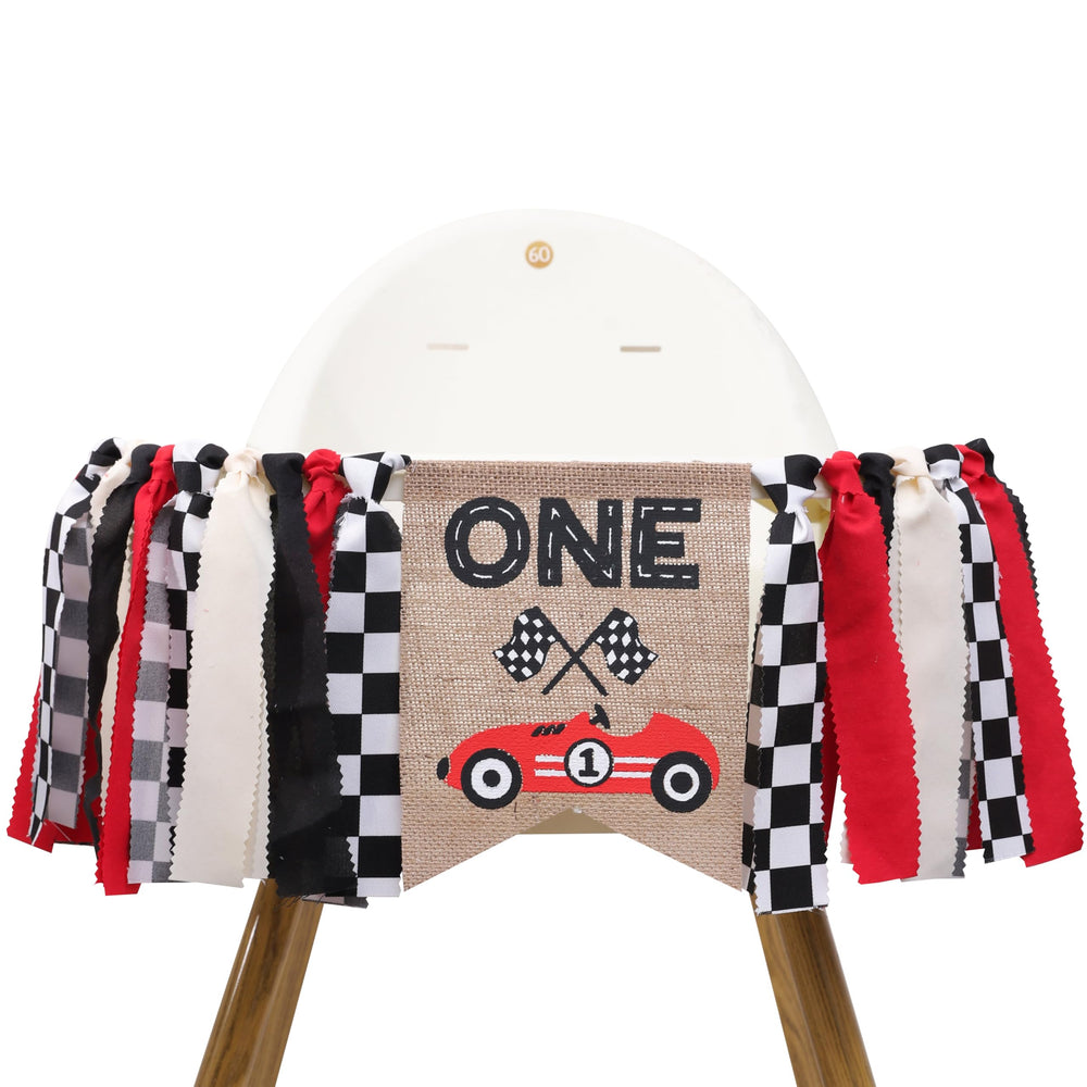 TUTOTU Race Car One High Chair Banner on a chair for a festive first birthday.