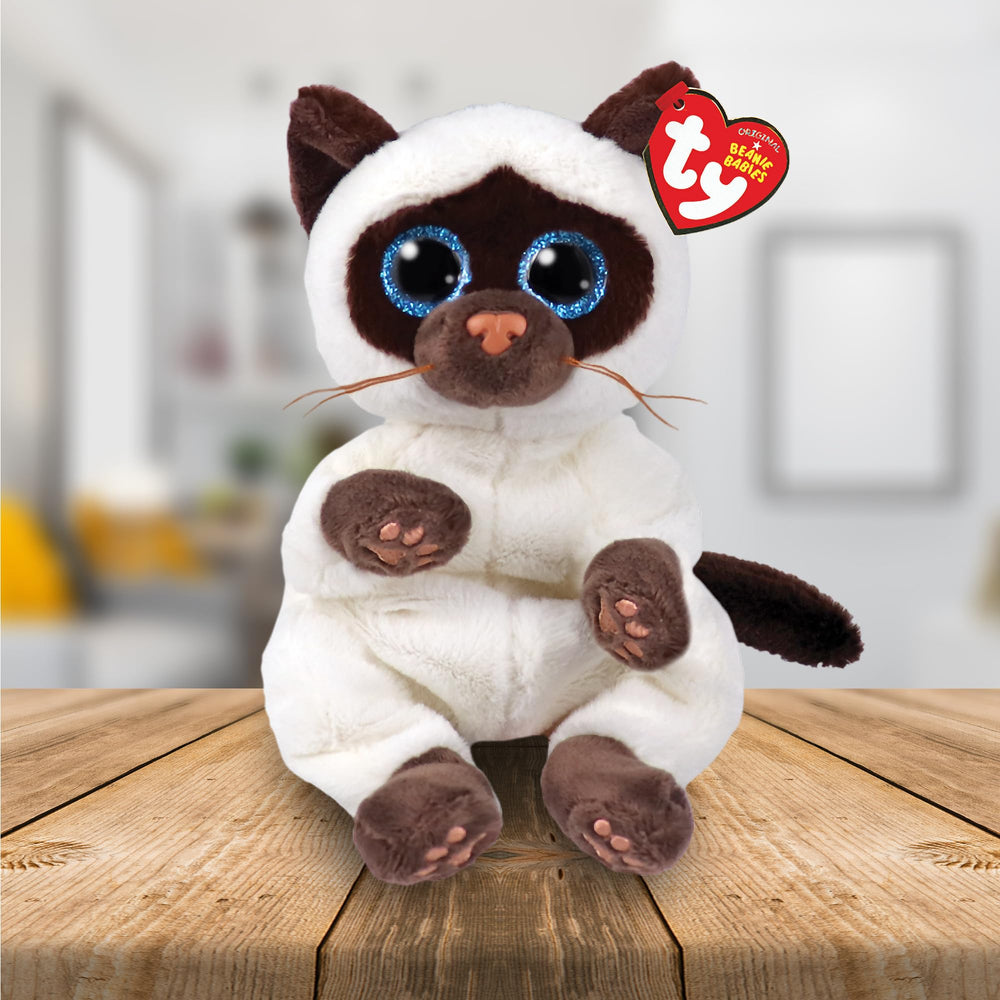 TY Beanie Babies Miso cat shown with other collectibles for display.