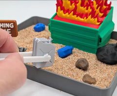 UglaForge Dumpster Fire Zen Garden closeup features tactile elements for relaxing sensory play.