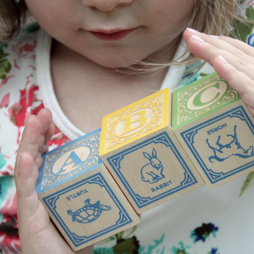 Handcrafted basswood blocks provide sturdy, tactile stacking experiences for curious hands.