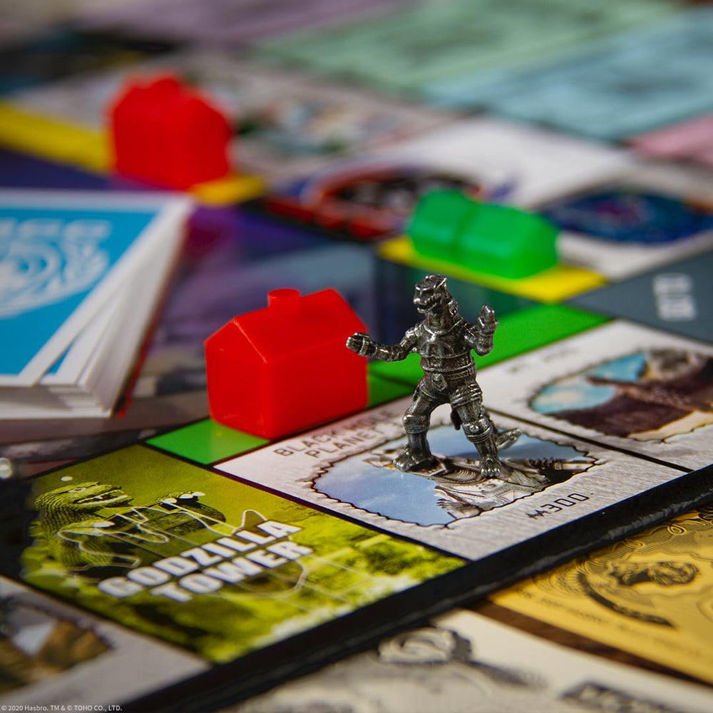 USAOPOLY Godzilla base pieces replace hotels for dramatic turns.