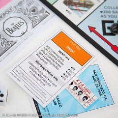 USAOPOLY Beatles Money, custom currency for themed transactions.