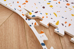 Valioza Terrazzo Playmat anti-slip surface helps keep babies steady.