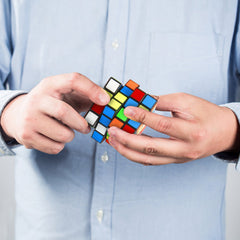 Hand holding the Vamslove 4x4x4 speed cube ready for portable brain teaser use.