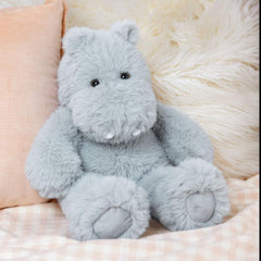 Hippo plush resting on a lap to invite snuggles.