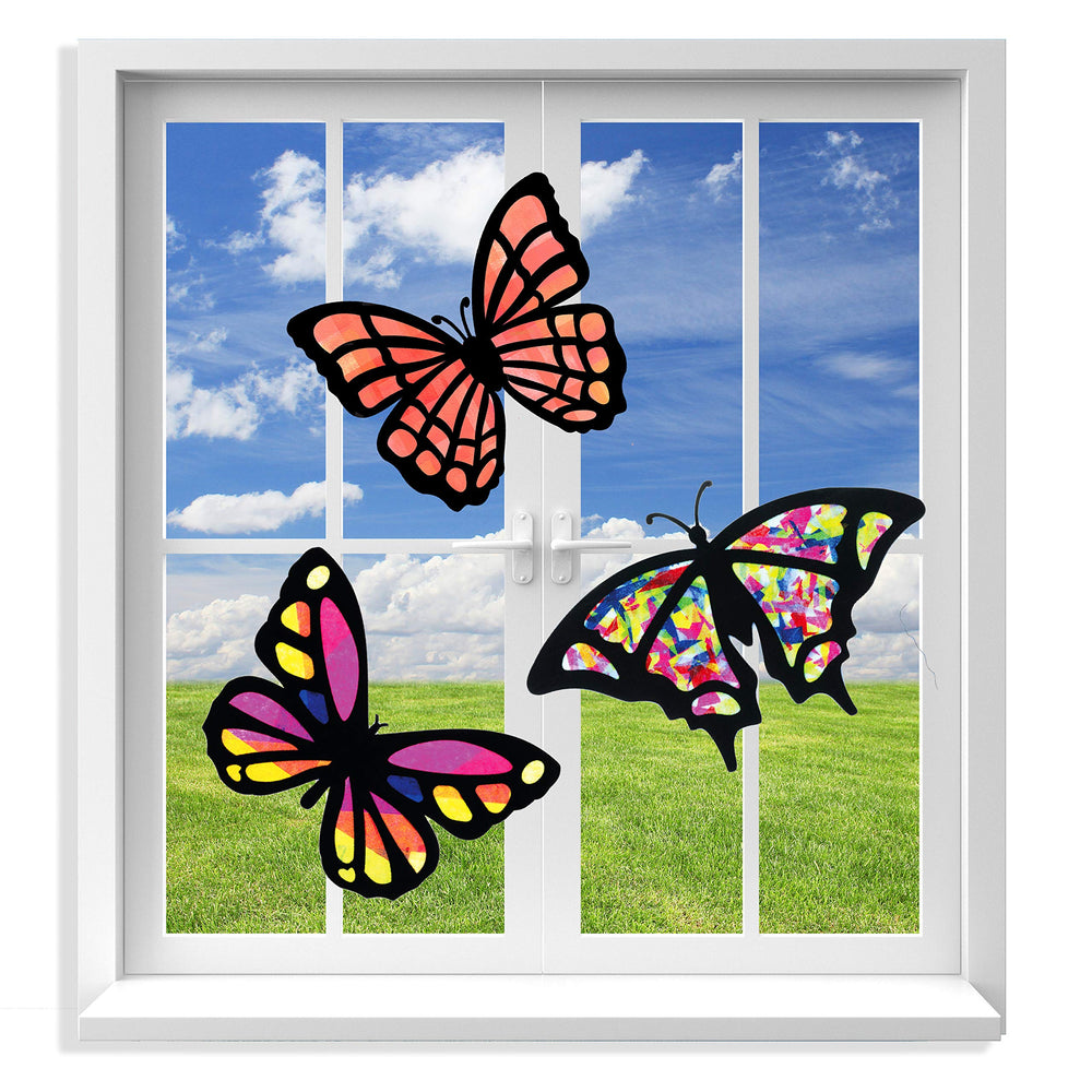 VHALE butterfly suncatcher kit in progress with colorful tissue near a sunlit window.