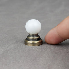 Diorama-ready brass ceiling light adds a gentle, diffused glow.