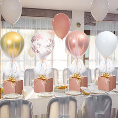 Wettarn rose gold confetti balloons with tulle tutu setup for an elegant table centerpiece.