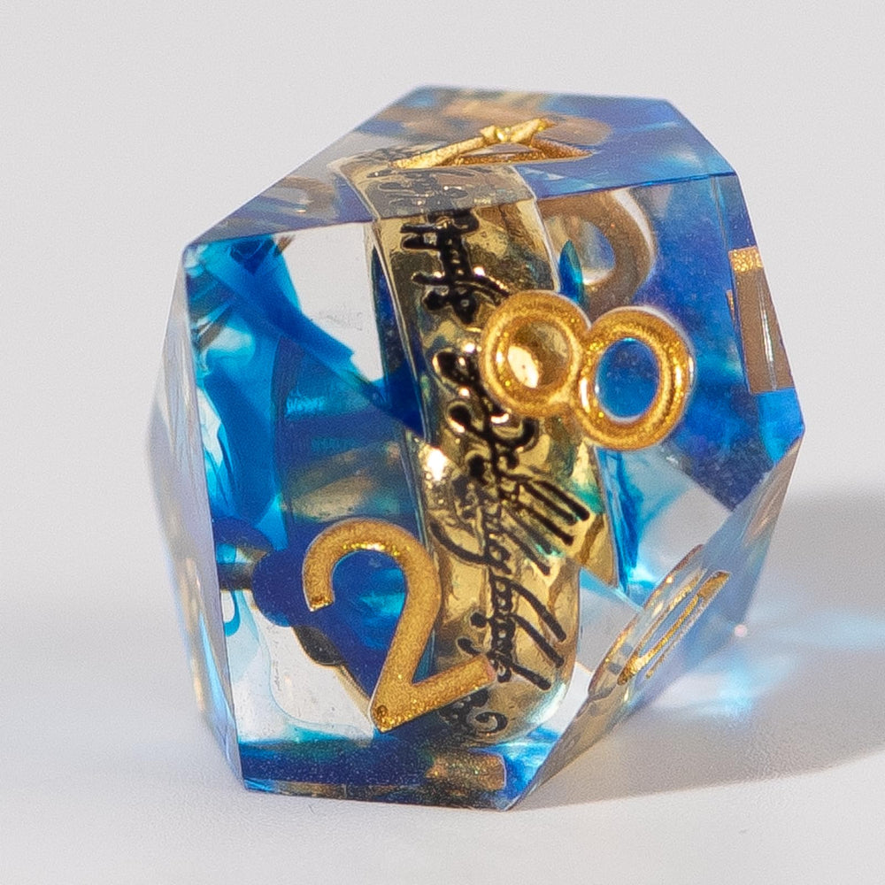 WizardsArcanum resin dice with readable ring inscriptions under light.