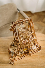 Wood Trick paw-start mechanism offers tactile marble release for precise launches.