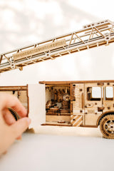 Wood Trick Rescue Firetruck spring motor powers forward motion up to 20 feet.