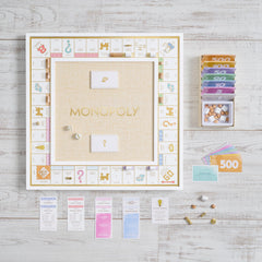 Monopoly Bianco gold-toned tokens shine, elevating premium play.